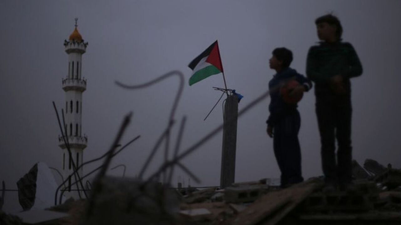 Palestinian flag flutters as Palestinian boys stand atop the rubble of a destroyed house in the northern Gaza Strip A Palestinian flag flutters as Palestinian boys stand atop the rubble of a house, which witness said was destroyed in an Israeli air strike during an eight-day conflict, in the northern Gaza Strip December 20, 2012. Eight days of Israeli air strikes on Gaza and cross-border Palestinian rocket attacks ended in an Egyptian-brokered truce agreement last month calling on Israel to ease restrictions on the territory. REUTERS/Mohammed Salem (GAZA - Tags: CONFLICT TPX IMAGES OF THE DAY)
