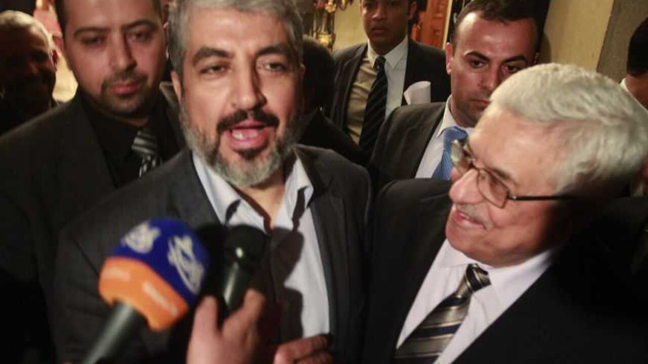 Hamas leader Meshaal and Palestinian President Abbas speak to the media after their meeting in Cairo Hamas leader Khaled Meshaal (L) and Palestinian President Mahmoud Abbas (R) speak to the media after their meeting in Cairo, February 22, 2012. REUTER/Asmaa Waguih (EGYPT - Tags: POLITICS)