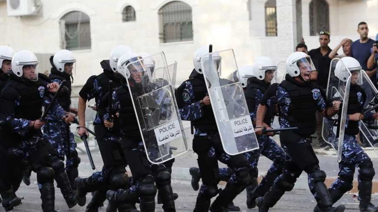 Palestinian police officers charge towards protesters during clashes at a demonstration against high living costs and the government in the West Bank city of Hebron Palestinian police officers charge towards protesters during clashes at a demonstration against high living costs and the government in the West Bank city of Hebron September 10, 2012. Palestinian youths attacked a local police station and other government buildings in Hebron on Monday as protests against the rising cost of living in the occupied West Bank turned increasingly violent. R EUTERS/Darren Whiteside (WEST BANK - Tags: POLITICS CIVIL UNREST)