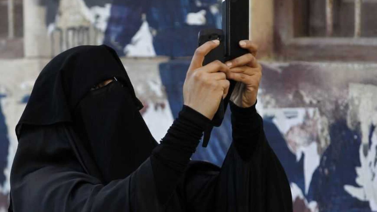 Protester uses a mobile device to take a video of an anti-government protest in the capital Manama A protester uses a mobile device to take a video of an anti-government protest in the capital Manama December 17, 2012. Protesters, shouting anti-government slogans, attempted to regroup from various points to march against a ban on demonstrations. Riot police dispersed them and arrested at least three protesters. REUTERS/Hamad I Mohammed (BAHRAIN - Tags: POLITICS CIVIL UNREST)