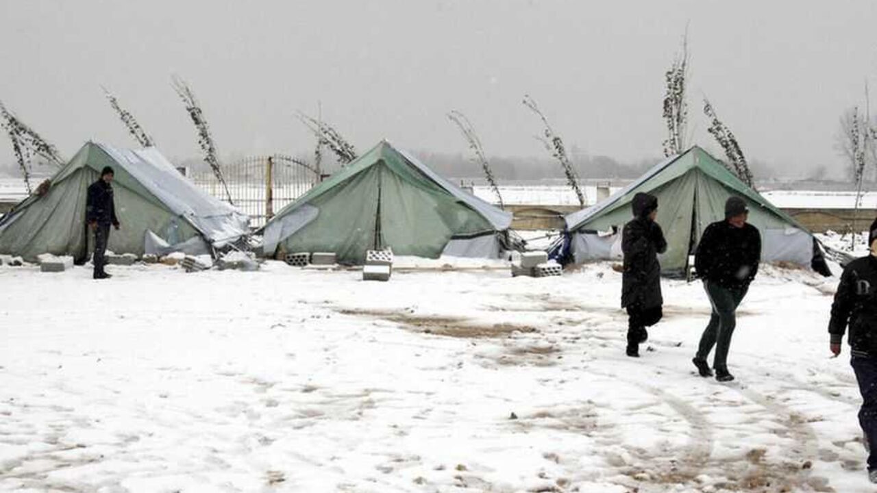 Syrian refugees stand in snow outside their tents during a winter storm in al-Marj, in the Bekaa valley Syrian refugees stand in snow outside their tents during a winter storm in al-Marj, in the Bekaa valley January 9, 2013. The worst winter storm in two decades has hit the eastern Mediterranean this week, bringing destruction and death to Syria and its neighbours who are already dealing with a refugee crisis from the country's civil war. REUTERS/Afif Diab (LEBANON - Tags: ENVIRONMENT DISASTER)