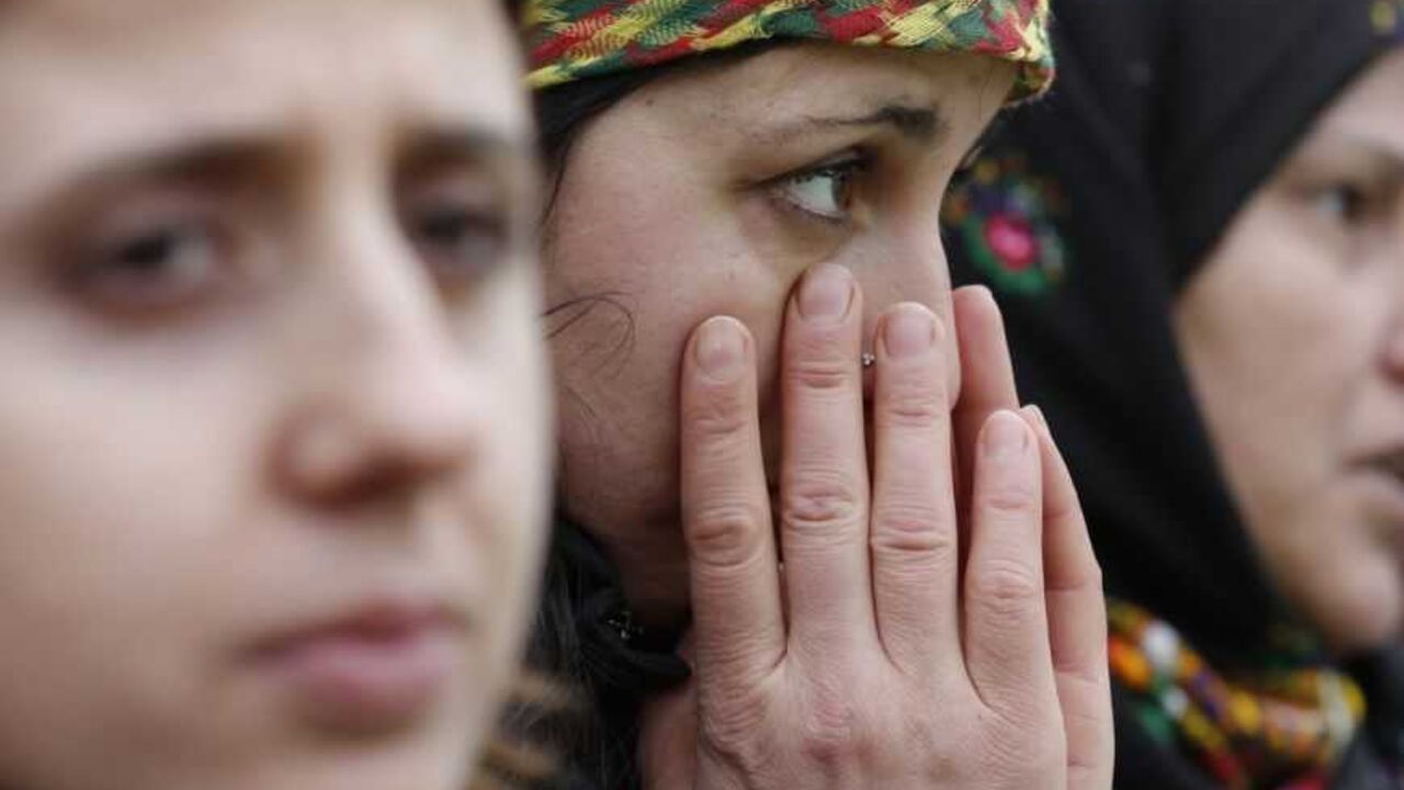 Members of the Kurdish community gather in front of the Gare de l'Est railway station, in tribute to the three Kurdish women found shot dead in Paris Members of the Kurdish community gather in front of the Gare de l'Est railway station, in tribute to the three Kurdish women found shot dead in Paris January 12, 2013. Three female Kurdish activists including a founding member of the PKK rebel group were found shot dead in Paris on Thursday, in execution-style killings condemned by Turkish politicians trying to broker a peace deal. REUTERS/Christian Hartmann (FRANCE - Tags: POLITICS CRIME LAW CIVIL UNREST)