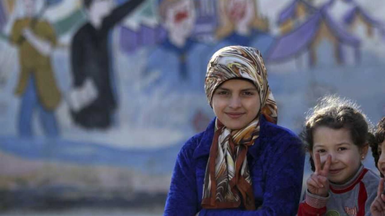 Internally displaced Syrian children gesture as they pose for a photo at a school in Aleppo Internally displaced Syrian children gesture as they pose for a photo at a school in Aleppo January 14, 2013. REUTERS/Muzaffar Salman (SYRIA - Tags: CONFLICT)