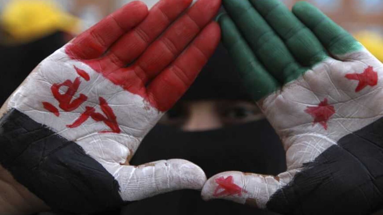 A pro-democracy protester displays her palms during a demonstration in Sanaa A pro-democracy protester displays her palms that are painted with the national colours of Syria during a demonstration in Sanaa January 17, 2013. The demonstrators were calling for Yemen's President Abd-Rabbu Mansour Hadi to make more decisions to complete the preparations for national dialogue and to demand that Yemen's former president Ali Abdullah Saleh be put on trial, according to organisers. REUTERS/Mohamed al-Sayaghi (YEMEN - Tags: CIVIL UNREST POLITICS)
