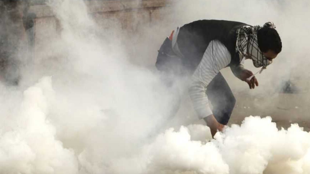 A protester against Egypt's President Mursi attempts to pick up a tear gas canister fired by riot police during clashes in Cairo A protester against Egypt's President Mohamed Mursi attempts to pick up a tear gas canister fired by riot police during clashes along Qasr Al Nil bridge leading to Tahrir Square in Cairo January 27, 2013. Mursi will address the nation on Sunday evening, state television said, after 45 people were killed in violent protests over the past four days. The television gave no further details. Opposition groups, who accuse the Islamist president of betraying the uprising which toppled Hosni Mubarak two years ago s