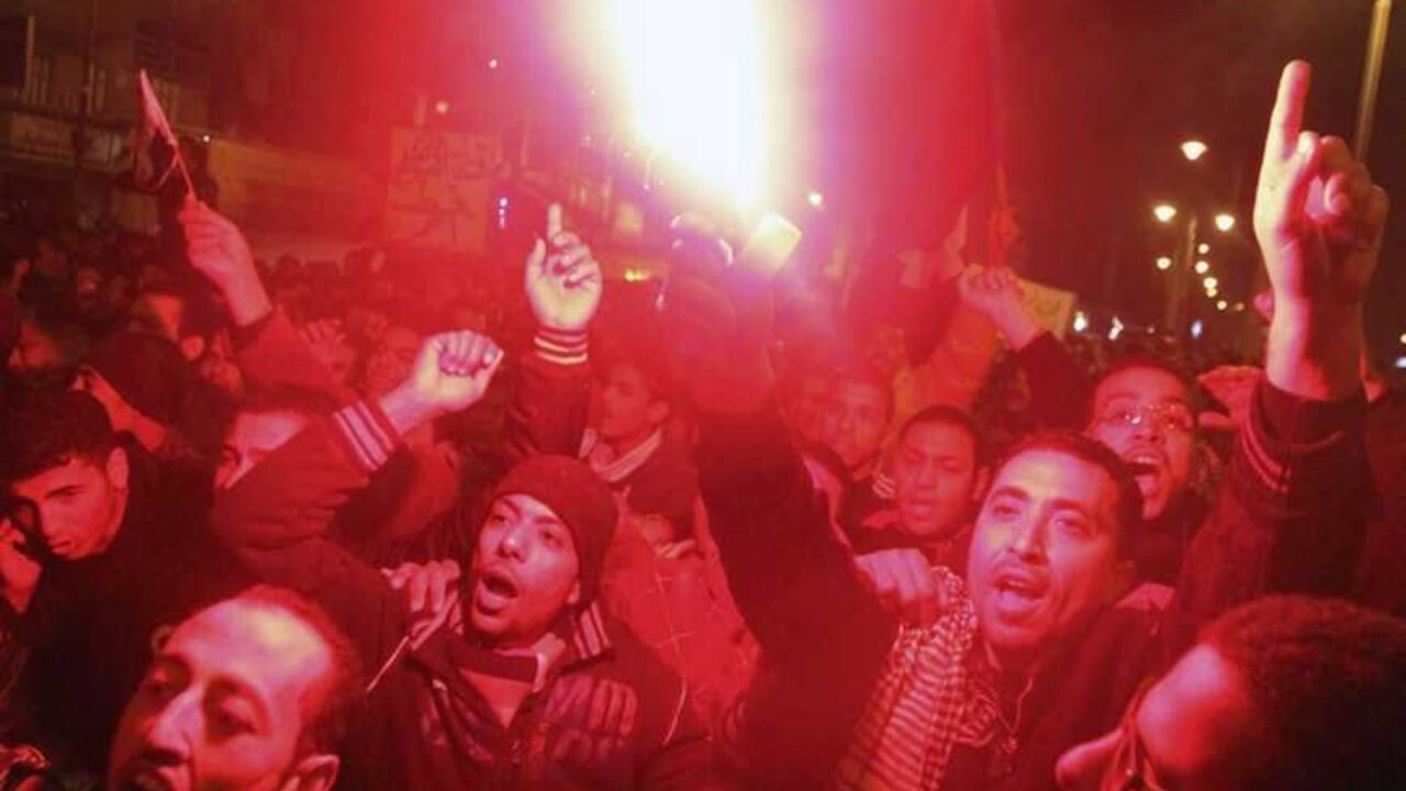 Protesters opposing Egyptian President Mursi shout slogans as they march despite a nighttime curfew in Suez Protesters opposing Egyptian President Mohamed Mursi shout slogans as they march despite a nighttime curfew in the city of Suez January 28, 2013. Egyptian protesters defied a nighttime curfew in restive towns along the Suez Canal, attacking police stations and ignoring emergency rule imposed by Islamist President Mohamed Mursi to end days of clashes that have killed at least 52 people. Egypt's army chief said political strife was pushing the state to the brink of collapse - a stark warning from the institut