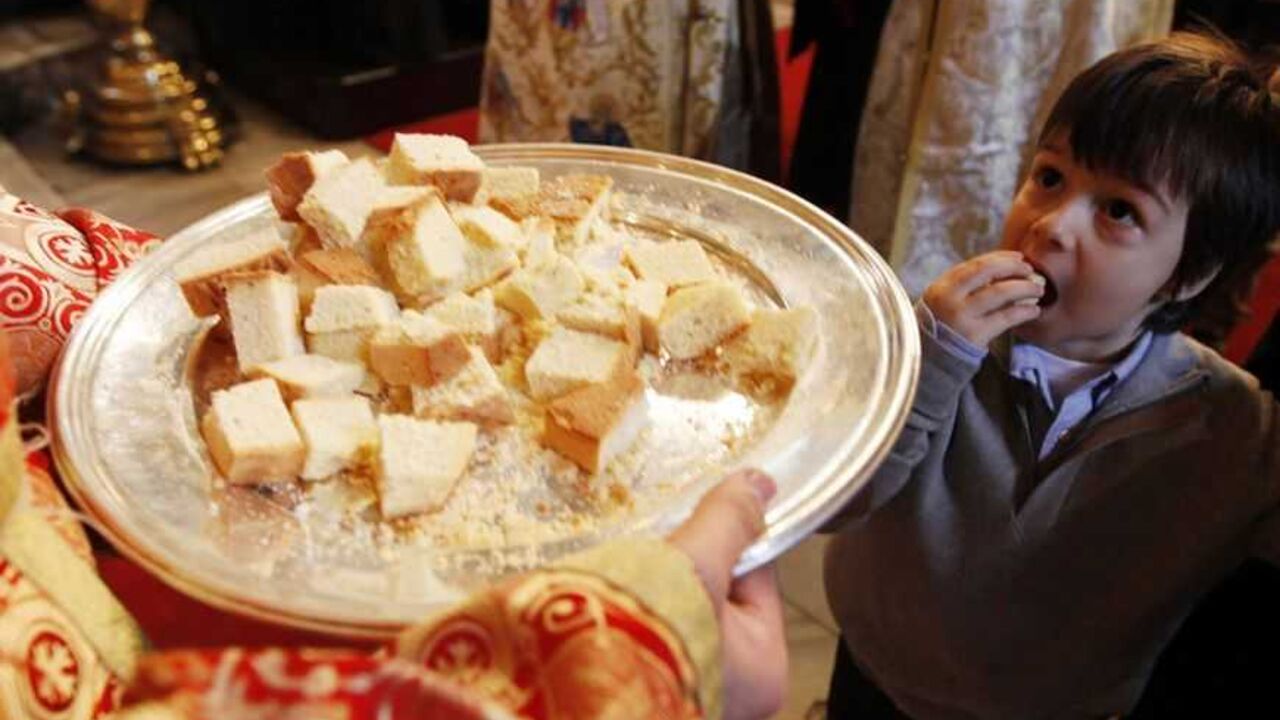 Yorgo Diagurisi eats bread during a Christmas mass at the Greek Orthodox patriarchal cathedral of St. George in Istanbul Yorgo Diagurisi, a four-year-old Greek Orthodox boy, eats bread during a Christmas mass at the Greek Orthodox patriarchal cathedral of St. George in Istanbul December 25, 2010. REUTERS/Murad Sezer (TURKEY - Tags: RELIGION SOCIETY)