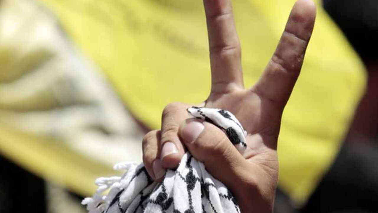 A Fatah supporter flashes a victory sign during a rally celebrating the reconciliation agreement between rival Palestinian factions Fatah and Hamas, in Gaza City A Fatah supporter flashes a victory sign during a rally celebrating the reconciliation agreement between rival Palestinian factions Fatah and Hamas, at al-Azhar University in Gaza City May 8, 2011. Palestinian President and Fatah leader Mahmoud Abbas and Hamas leader Khaled Meshaal endorsed on May 4 a deal to end a four-year rift between the secular Fatah group and its Islamist rival. REUTERS/Ismail Zaydah (GAZA - Tags: POLITICS CIVIL UNREST)