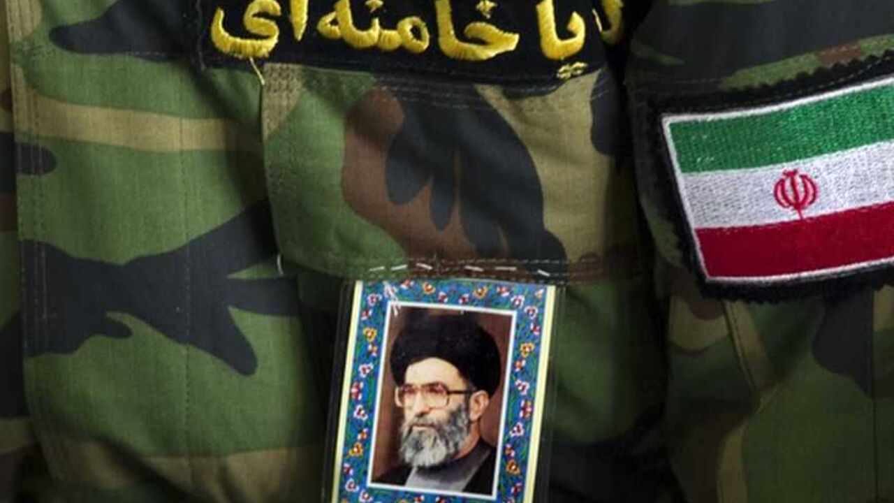 A worshipper pastes a portrait of Iran's Supreme Leader Ayatollah Ali Khamenei, a flag and a Persian script that reads, "Hey Khamenei" on a Revolutionary Guard uniform as he attends Friday prayers in Tehran EDITORS' NOTE: Reuters and other foreign media are subject to Iranian restrictions on leaving the office to report, film or take pictures in Tehran.
A worshipper pastes a portrait of Iran's Supreme Leader Ayatollah Ali Khamenei, a flag and a Persian script that reads, "Hey Khamenei" on a Revolutionary Guard uniform as he attends Friday prayers in Tehran February 10, 2012. REUTERS/Morteza Nikoubazl (IRAN - Tags: POLITICS RELIGION MILITARY)