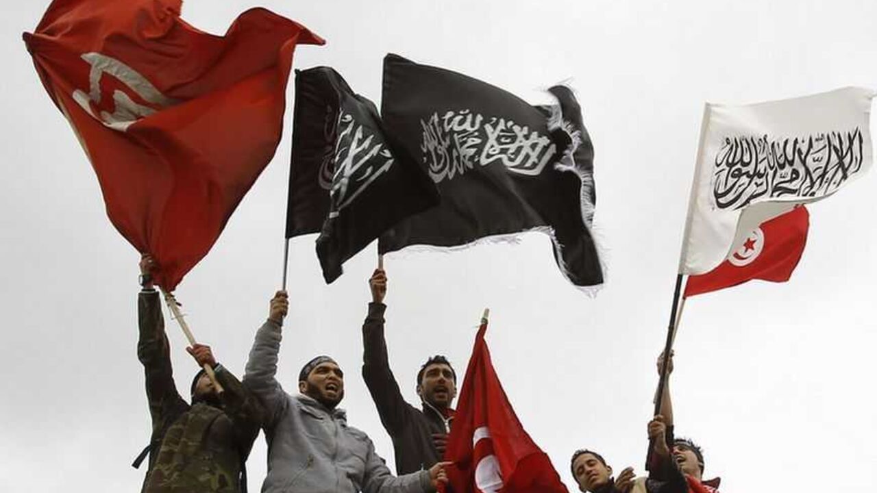 Salafist protesters wave flags during a protest in front of the Tunisian TV headquarters in Tunis Salafist protesters wave flags during a protest in front of the Tunisian TV headquarters in Tunis March 9, 2012. REUTERS/Zoubeir Souissi (TUNISIA - Tags: MEDIA CIVIL UNREST POLITICS RELIGION) - RTR2Z4C1