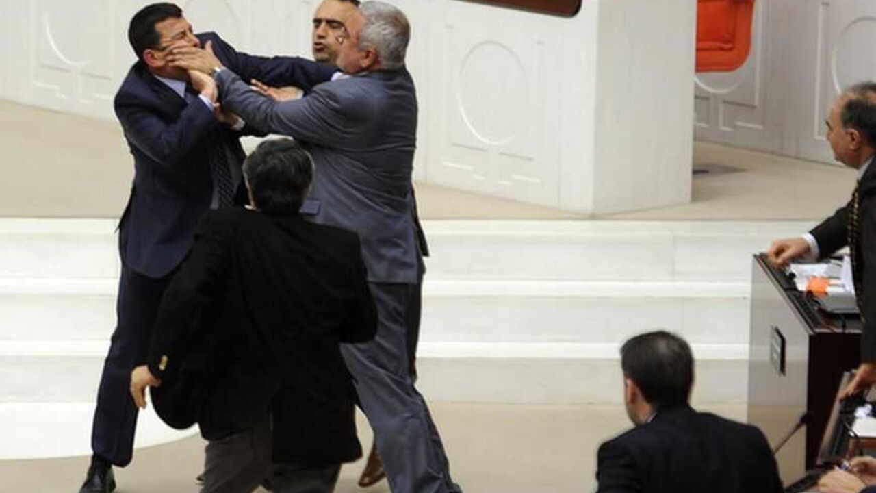 Members of parliament from the ruling AK Party and Republican People's Party scuffle during a debate at the parliament in Ankara Members of parliament from the ruling AK Party (AKP) and Republican People's Party (CHP) scuffle during a debate at the parliament in Ankara early March 30, 2012. The Turkish parliament is hotly debating a bill overturning a 1997 law, imposed with the backing of the military, which extended compulsory education to eight from five years and stopped under-15s attending religious "imam hatip" schools. Parliamentarians on Thursday accepted a proposal from Prime Minister Tayyip Erdogan's AK Party to offer option