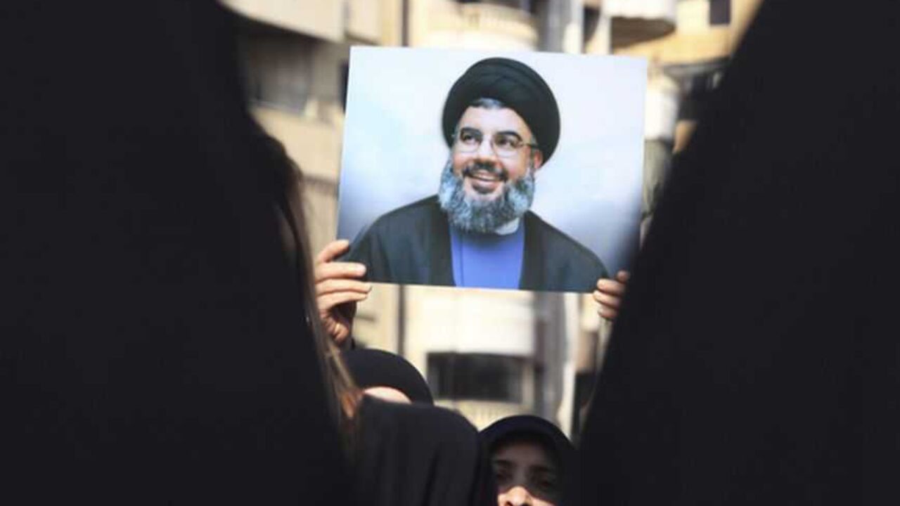 A Lebanese Hezbollah supporter carries a picture of Hezbollah leader Sayyed Hassan Nasrallah as she takes part in a ceremony marking Ashura in Beirut's suburbs A Lebanese Hezbollah supporter carries a picture of Hezbollah leader Sayyed Hassan Nasrallah as she takes part in a ceremony marking Ashura in Beirut's suburbs, November 25, 2012. Hezbollah leader Sayyed Hassan Nasrallah warned Israel on Sunday that thousands of rockets would rain down on Tel Aviv and other Israeli cities if Israel attacked Lebanon. In a speech marking the Shi'ite Muslim festival of Ashura, Nasrallah said Hezbollah's response to any attack would dwarf the attacks from Gaza during the eight-