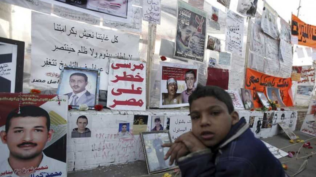 A boy sits in front of a "Revolution Museum", dedicated to protesters killed during Egypt's uprising, set up by protesters against Egypt's President Mursi at Tahrir Square in Cairo Mahmoud, 9, sits in front of a "Revolution Museum", dedicated to protesters killed during Egypt's uprising, set up by protesters against Egypt's President Mohamed Mursi at Tahrir Square in Cairo December 17, 2012. Egypt's opposition called for nationwide protests against a constitution backed by Mursi, after a vote exposed deep divisions that could undermine his efforts to build consensus for tough economic measures. REUTERS/Amr Abdallah Dalsh (EGYPT - Tags: POLITICS CIVIL UNREST)