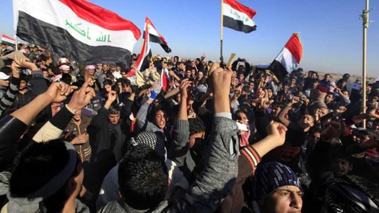Iraqi Sunni Muslims wave Iraqi national flags during an anti-government demonstration in Falluja Iraqi Sunni Muslims wave Iraqi national flags during an anti-government demonstration in Falluja, 50 km (30 miles) west of Baghdad, December 28, 2012. Tens of thousands of protesters from Iraq's Sunni Muslim minority poured onto the streets after Friday prayers in a show of force against Shi'ite Prime Minister Nuri al-Maliki, keeping up a week-old blockade of a highway. Around 60,000 people blocked the main road through the city of Falluja, setting fire to the Iranian flag and shouting "out, out Iran! Baghd