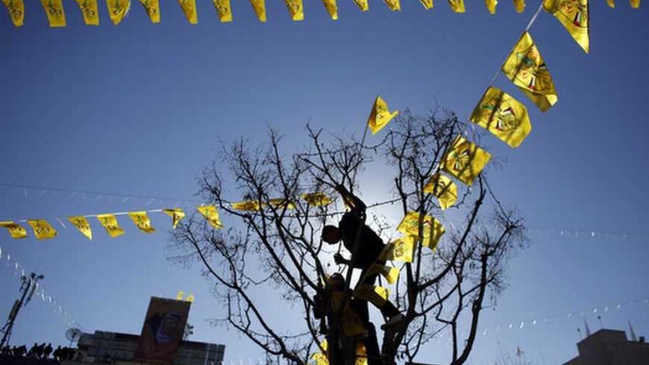 Palestinian youths are silhouetted as they hang a string of Fatah flags during a rally in Bethlehem Palestinian youths are silhouetted as they hang a string of Fatah flags during a rally marking the 48th anniversary of the founding of the Fatah movement in the West Bank town of Bethlehem December 31, 2012. REUTERS/Ammar Awad (WEST BANK - Tags: POLITICS ANNIVERSARY CIVIL UNREST TPX IMAGES OF THE DAY)