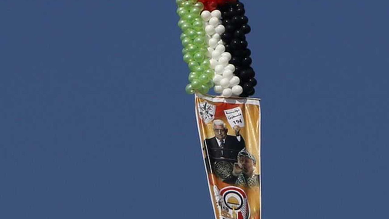 A balloon attached to a poster depicting Palestinian President Abbas and late Palestinian leader Arafat flies during a rally in Gaza A balloon attached to a poster depicting Palestinian President Mahmoud Abbas and late Palestinian leader Yasser Arafat flies during a rally marking the 48th anniversary of the founding of the Fatah movement, in Gaza City January 4, 2013. Hundreds of thousands of Palestinians joined a rare rally staged by President Mahmoud Abbas's Fatah group in Gaza on Friday, as tensions ease with rival Hamas Islamists ruling the enclave since 2007. REUTERS/Suhaib Salem (GAZA - Tags: POLITICS ANNIVERSARY)