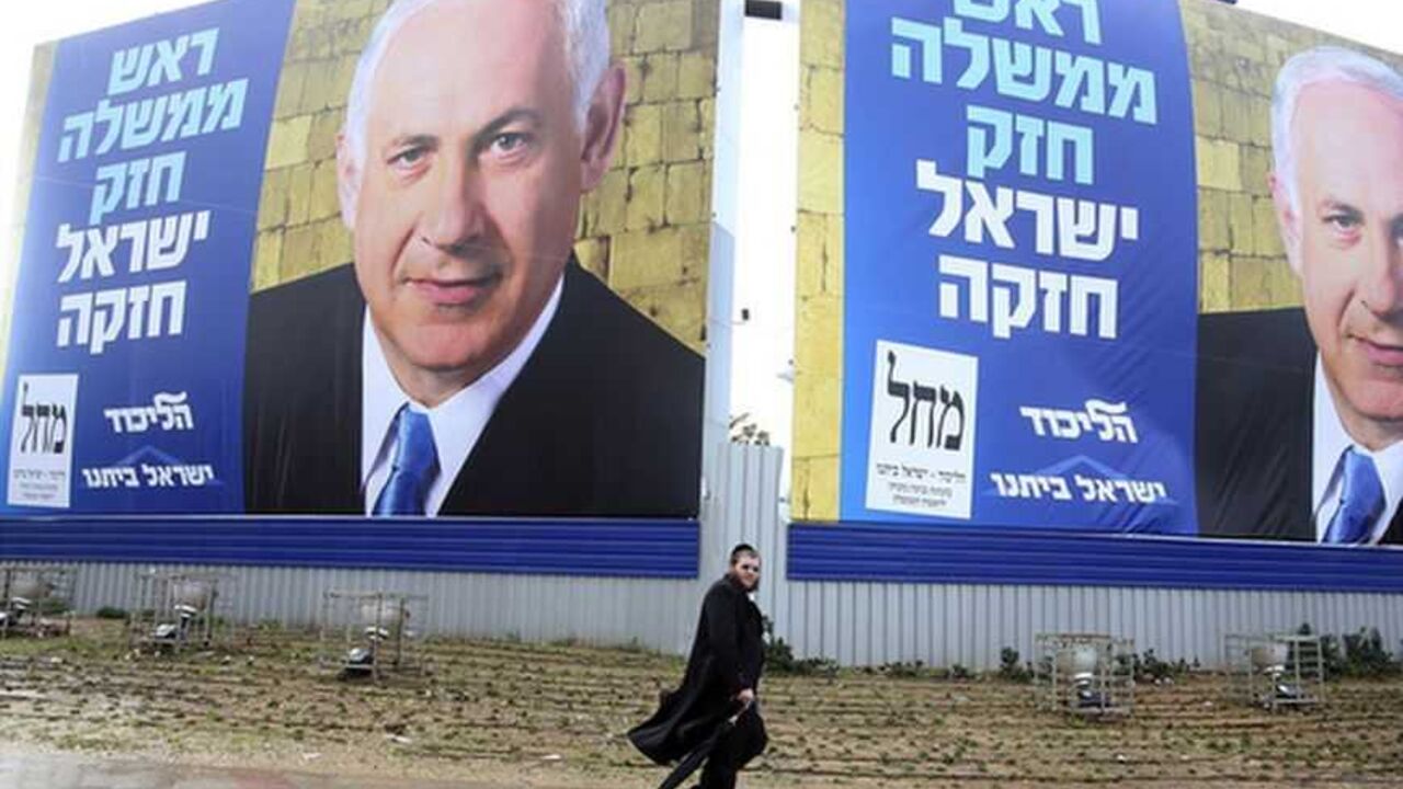 A pedestrian walks past posters depicting Netanyahu near Tel Aviv A pedestrian walks past campaign posters depicting Israel's Prime Minister Benjamin Netanyahu in Bnei Brak near Tel Aviv January 7, 2013. Three Israeli centrist and left-leaning parties have failed in an initial attempt to form a united bloc that might have cut into Netanyahu's opinion poll lead before the Jan. 22 election. REUTERS/Baz Ratner (ISRAEL - Tags: POLITICS ELECTIONS)