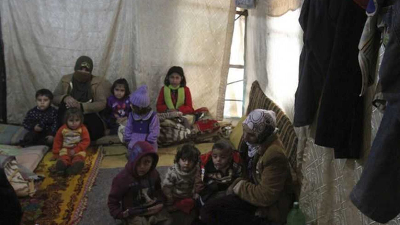 A Syrian refugee woman carries her child as they sit inside a tent near Tripoli A Syrian refugee woman carries her child as they sit inside a tent near Tripoli January 9,2013. More than 600,000 Syrian refugees have fled to neighbouring countries exposed to the storm. Many in Lebanon and Jordan were forced to move after their tents were flooded. REUTERS/Omar Ibrahim (LEBANON - Tags: ENVIRONMENT DISASTER CIVIL UNREST)