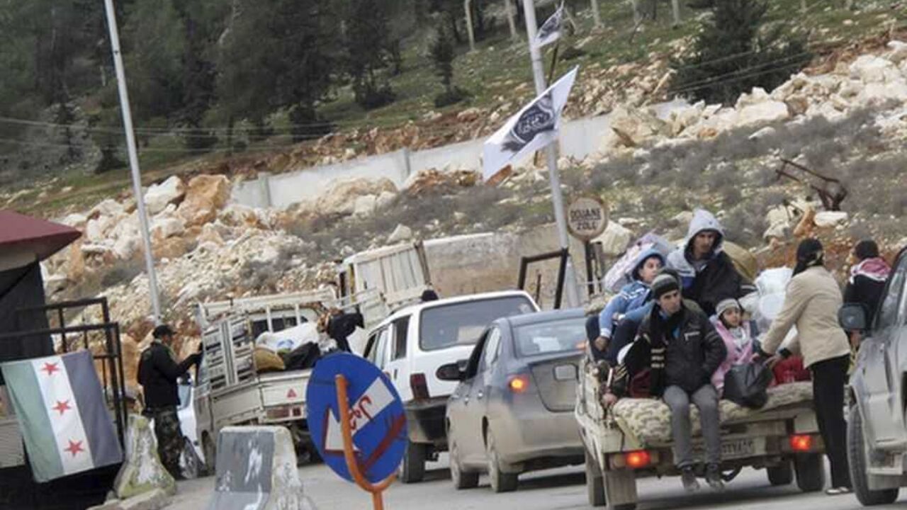 Syrian refugees wait to cross the border to Turkey at Bab El-Hawa Syrian refugees wait to cross the border to Turkey at Bab El-Hawa on the outskirts of Idlib, near the Syrian-Turkey border, January 13, 2013. Picture taken January 13, 2013. REUTERS/Abdalghne Karoof (SYRIA - Tags: CIVIL UNREST POLITICS CONFLICT SOCIETY)