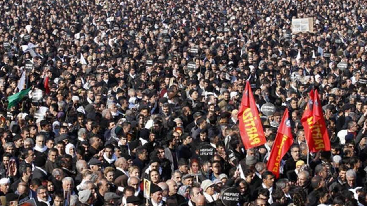 Thousands attend the funeral ceremony of the three Kurdish activists shot in Paris, in Diyarbakir, the largest city in Turkey's mainly Kurdish southeast, January 17, 2013. The bodies of the activists, including that of Kurdistan Workers Party (PKK) co-founder Sakine Cansiz, arrived by plane on Wednesday evening in Diyarbakir. REUTERS/Umit Bektas (TURKEY - Tags: POLITICS OBITUARY CIVIL UNREST)