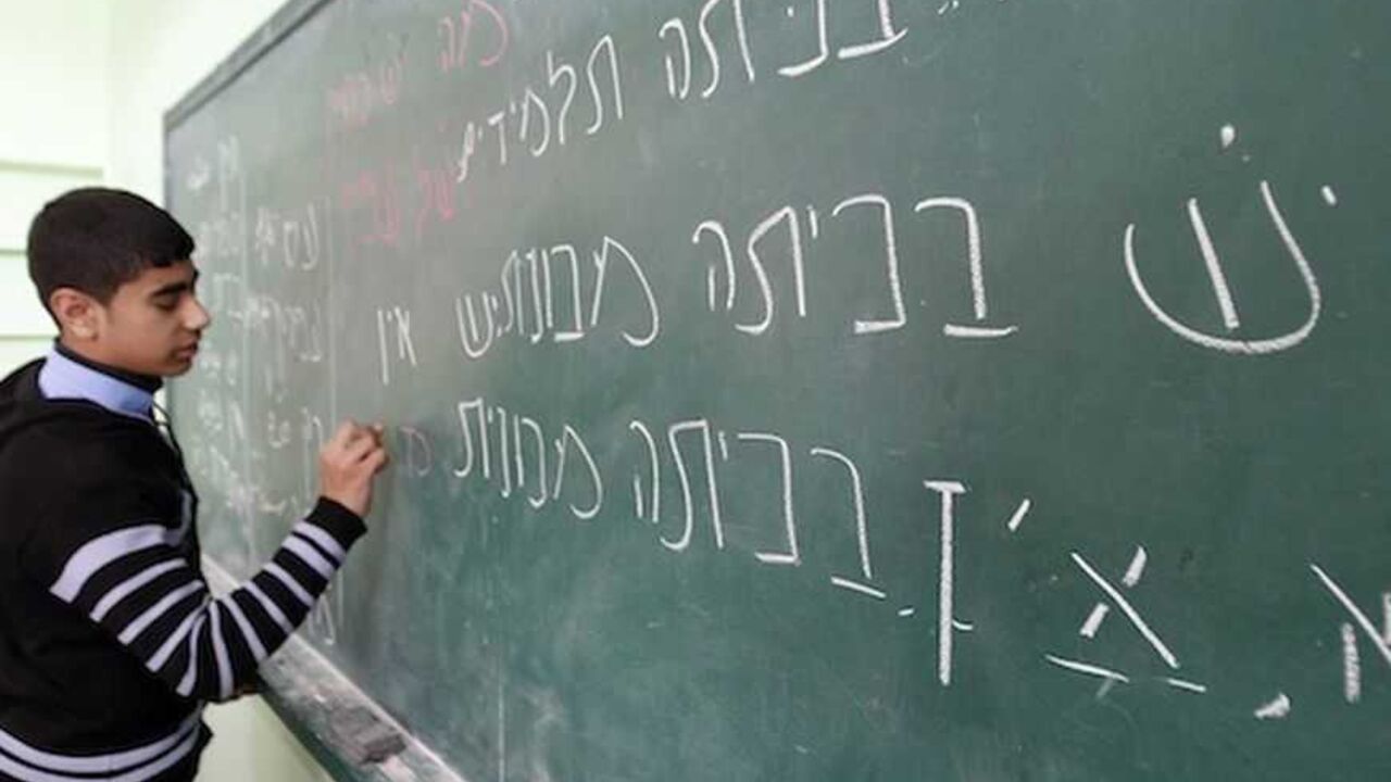 Palestinian ninth grade student writes on the blackboard during a Hebrew class at a Gaza school in Gaza City A Palestinian ninth grade student writes on the blackboard during a Hebrew class at a Gaza school in Gaza City January 28, 2013. REUTERS/Ahmed Zakot (GAZA - Tags: EDUCATION) - RTR3D31S