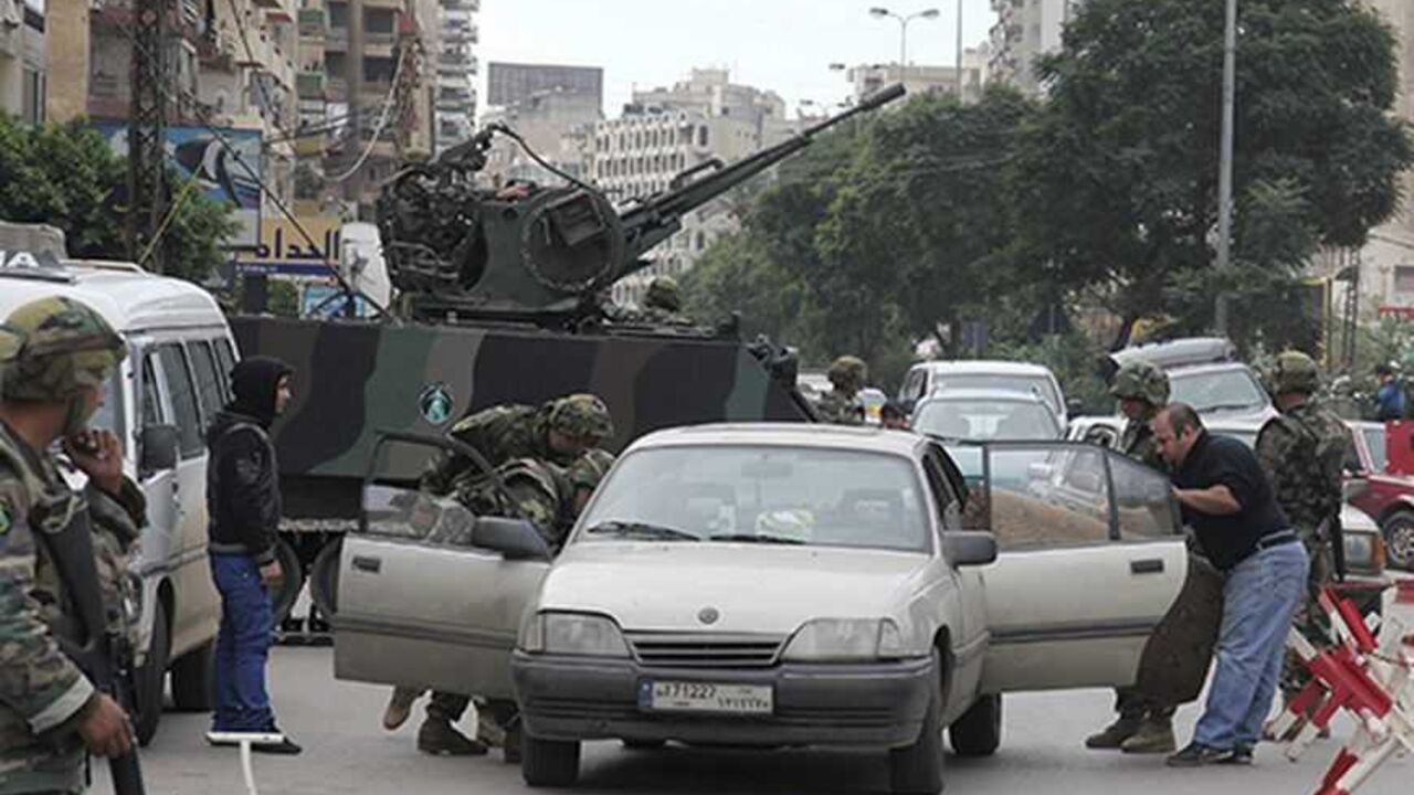 SYRIA-CRISIS/TRIPOLI Lebanese army soldiers inspect a car at a checkpoint in the port city of Tripoli, northern Lebanon, during clashes between Sunni Muslims and Alawites December 6, 2012. Two men were killed by sniper fire in Tripoli on Thursday during sectarian clashes between gunmen loyal to opposing sides in neighbouring Syria's civil war, residents said. REUTERS/Stringer (LEBANON - Tags: POLITICS CIVIL UNREST MILITARY TRANSPORT)