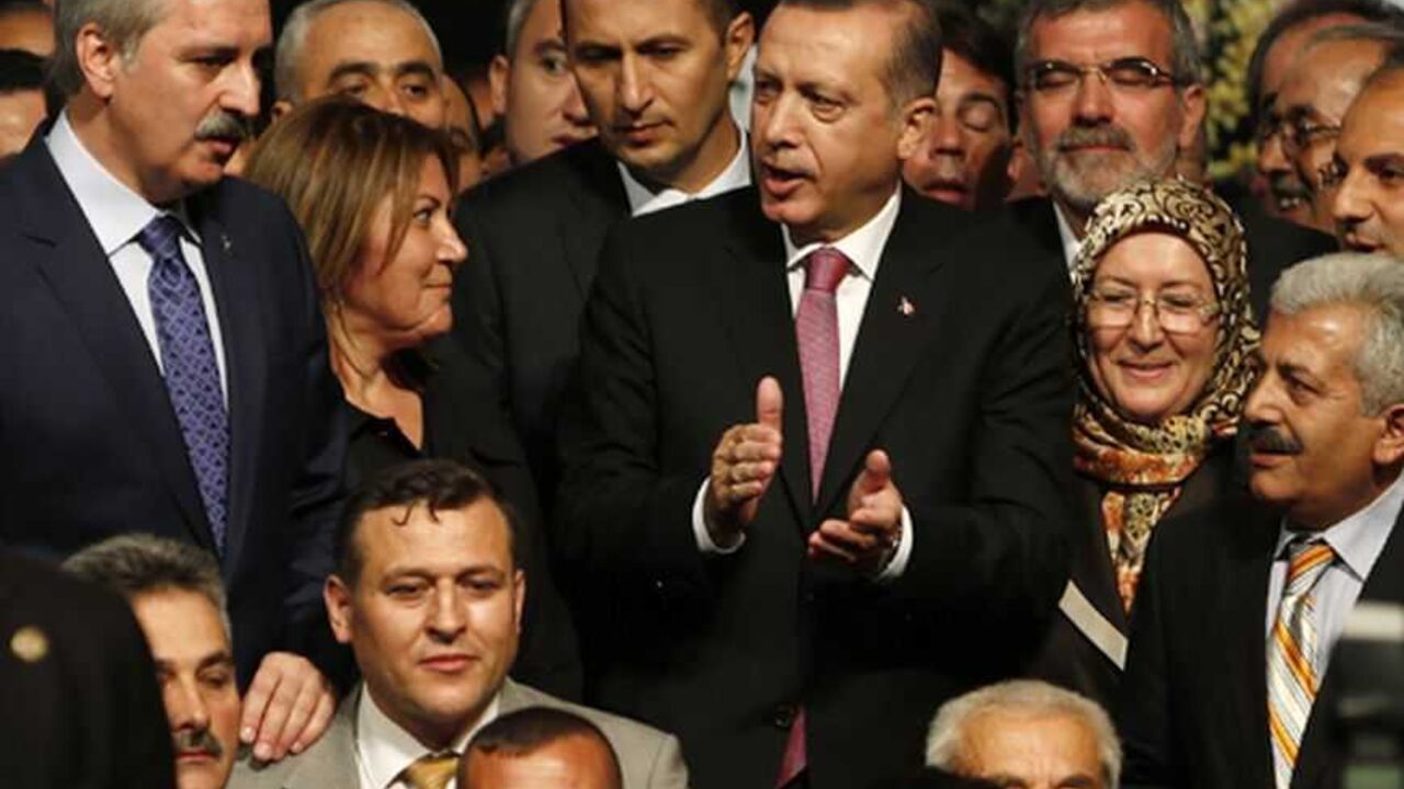 TURKEY-AKP/ Turkey's Prime Minister and leader of Justice and Development Party (AKP) Tayyip Erdogan (C), accompanied by Numan Kurtulmus, head of the former Islamist-rooted HAS Party (L), pose with the new members of his party during a party meeting in Istanbul September 22, 2012. The party's September 30, 2012 congress is unlikely to offer any sign Prime Minister Erdogan, viewed by many Turks as their strongest leader since Ataturk, is loosening his grip on a heavily-centralised party or on the country as a whole. P