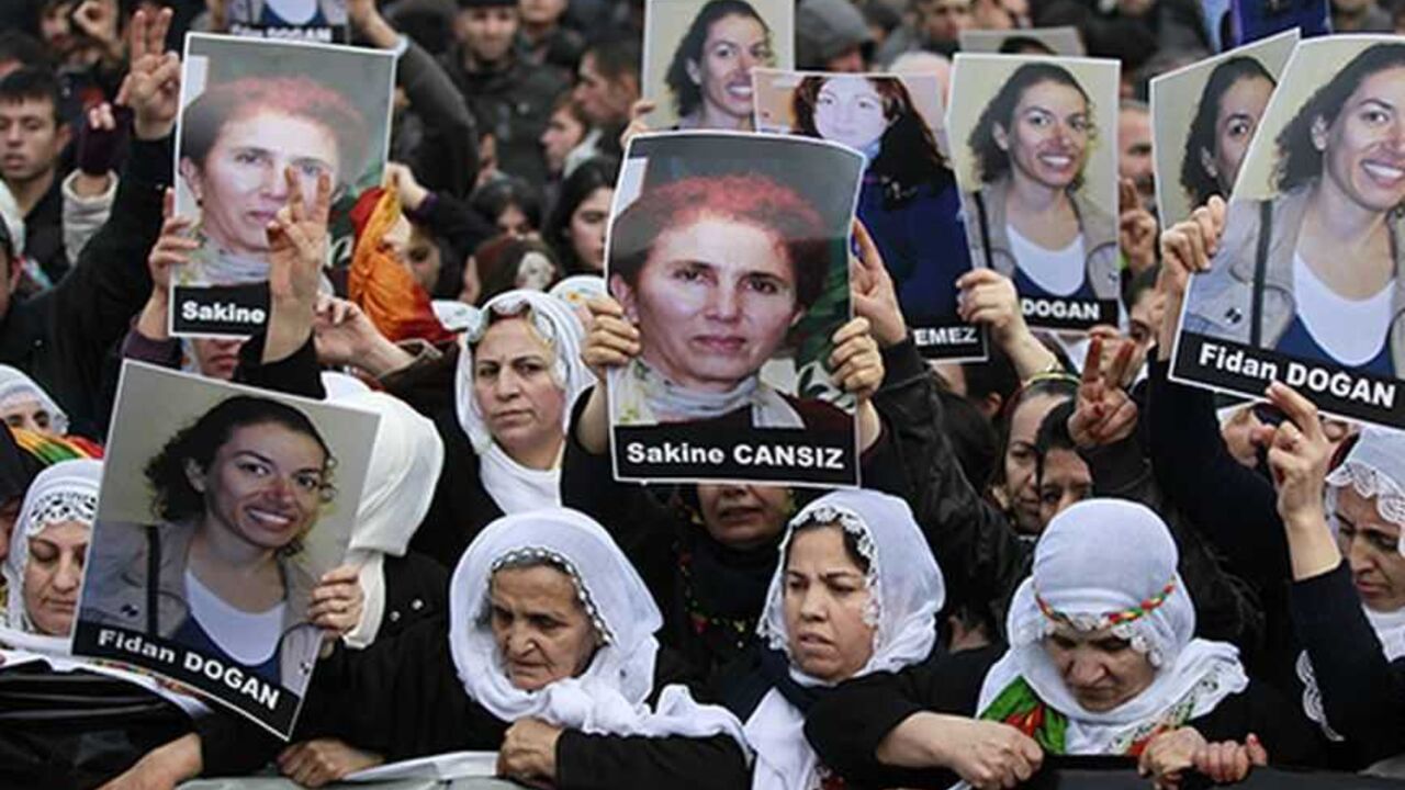 TURKEY-KURDS/ Pro-Kurdish demonstrators march with pictures of slain Kurdish activists Sakine Cansiz and Fidan Dogan during a protest at the Ataturk International Airport in Istanbul January 16, 2013. Three female Kurdish activists, including a founding member of the PKK rebel group, were found shot dead in Paris on Thursday, in execution-style killings condemned by Turkish politicians trying to broker a peace deal. REUTERS/Osman Orsal (TURKEY - Tags: POLITICS CIVIL UNREST)