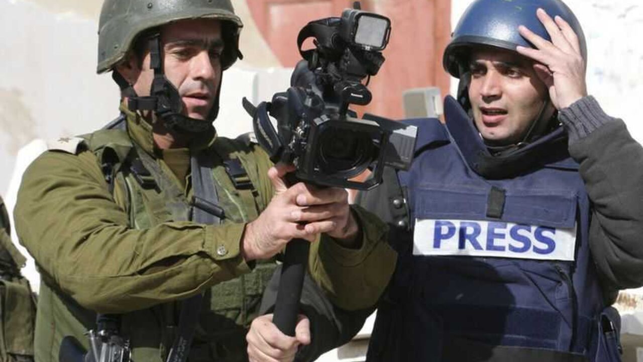 Israeli army officer grabs camera from Reuters cameraman in Hebron An Israeli army officer (C) grabs a camera from Reuters cameraman Yusri al-Jamal as he prevents him from covering news events in the West Bank city of Hebron January 2, 2009. REUTERS/Stringer (WEST BANK) - RTR2302T