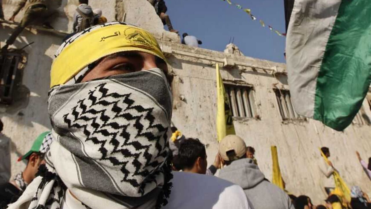 A masked Palestinian wearing Fatah headband takes part in a rally marking the 48th anniversary of the founding of the Fatah movement in Gaza City A masked Palestinian wearing a Fatah headband takes part in a rally marking the 48th anniversary of the founding of the Fatah movement, in Gaza City January 4, 2013. Hundreds of thousands of Palestinians joined a rare rally staged by President Mahmoud Abbas's Fatah group in Gaza on Friday, as tensions ease with rival Hamas Islamists ruling the enclave since 2007. REUTERS/Mohammed Salem (GAZA - Tags: POLITICS ANNIVERSARY TPX IMAGES OF THE DAY) - RTR3C3IA