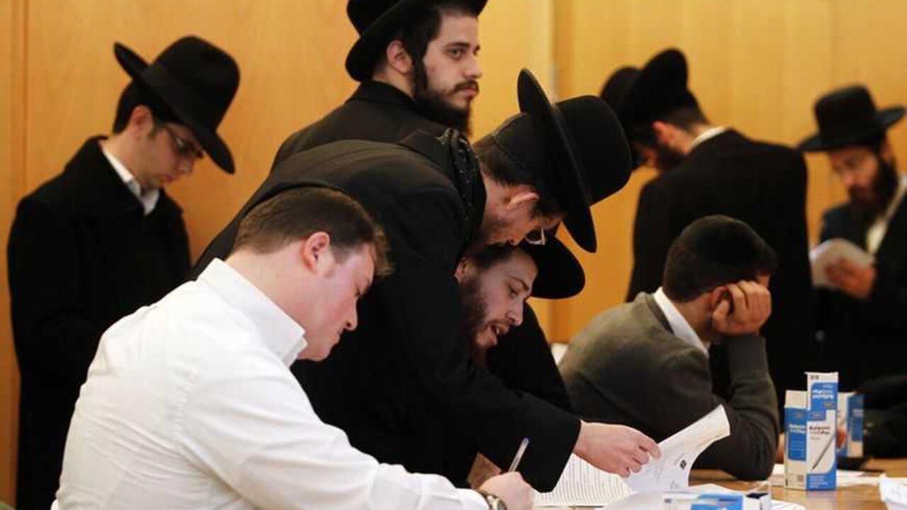 Ultra-Orthodox Jewish men sign documents at the offices of Israel's Administration for National Civil Service in Jerusalem Ultra-Orthodox Jewish men sign documents at the offices of Israel's Administration for National Civil Service in Jerusalem January 6, 2013. For the first time since the August 1 expiration of the so-called Tal Law that exempted ultra-Orthodox seminary students from military conscription, dozens of scholars signed up on Sunday for alternative civilian service which, upon completion, will entitle them to avoid the draft. Some 1,300 seminary students are slated to join the program by August 2013, or until Isra