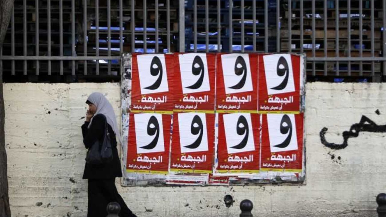 A woman walks past campaign posters for the Arab-led Hadash party in Umm al-Fahm A woman walks past campaign posters for the Arab-led Hadash party in the Israeli-Arab city of Umm al-Fahm December 26, 2012. Disillusioned, disappointed and divided, Israeli Arab voters will traipse to the polls next week in ever dwindling numbers, aware that none of their community will have any say in how the country is run. Picture taken December 26, 2012. REUTERS/Ammar Awad (ISRAEL - Tags: POLITICS ELECTIONS) - RTR3CHRM