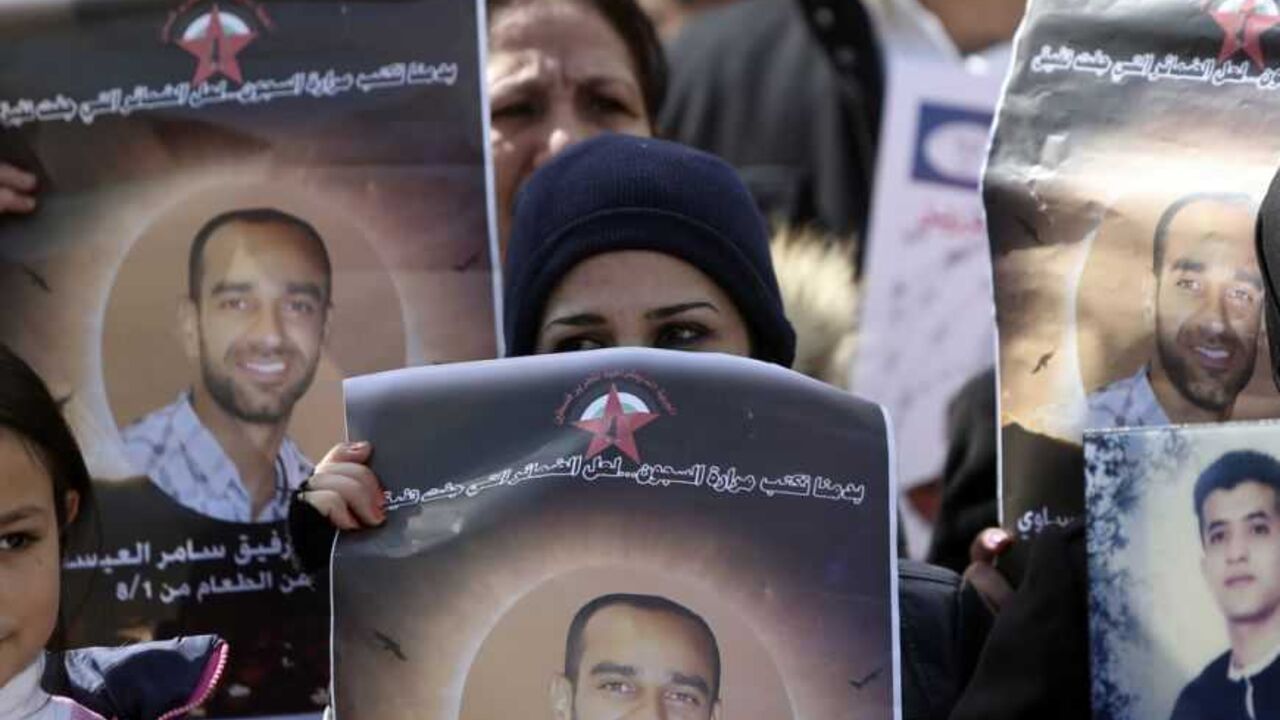 Palestinians hold placards depicting prisoner Samer al-Issawi during a protest in Ramallah Palestinians hold placards depicting prisoner Samer al-Issawi, who has been on hunger strike for 209 days, during a protest in the West Bank city of Ramallah, calling for the release of Palestinian prisoners from Israeli jails, February 17, 2013. The European Union on Saturday called on Israel to improve conditions for Palestinians in its jails, and a Palestinian minister said there would be rallies this week to support hunger striking prisoners. Nearly 5,000 Palestinians are held in Israeli jails, many cha