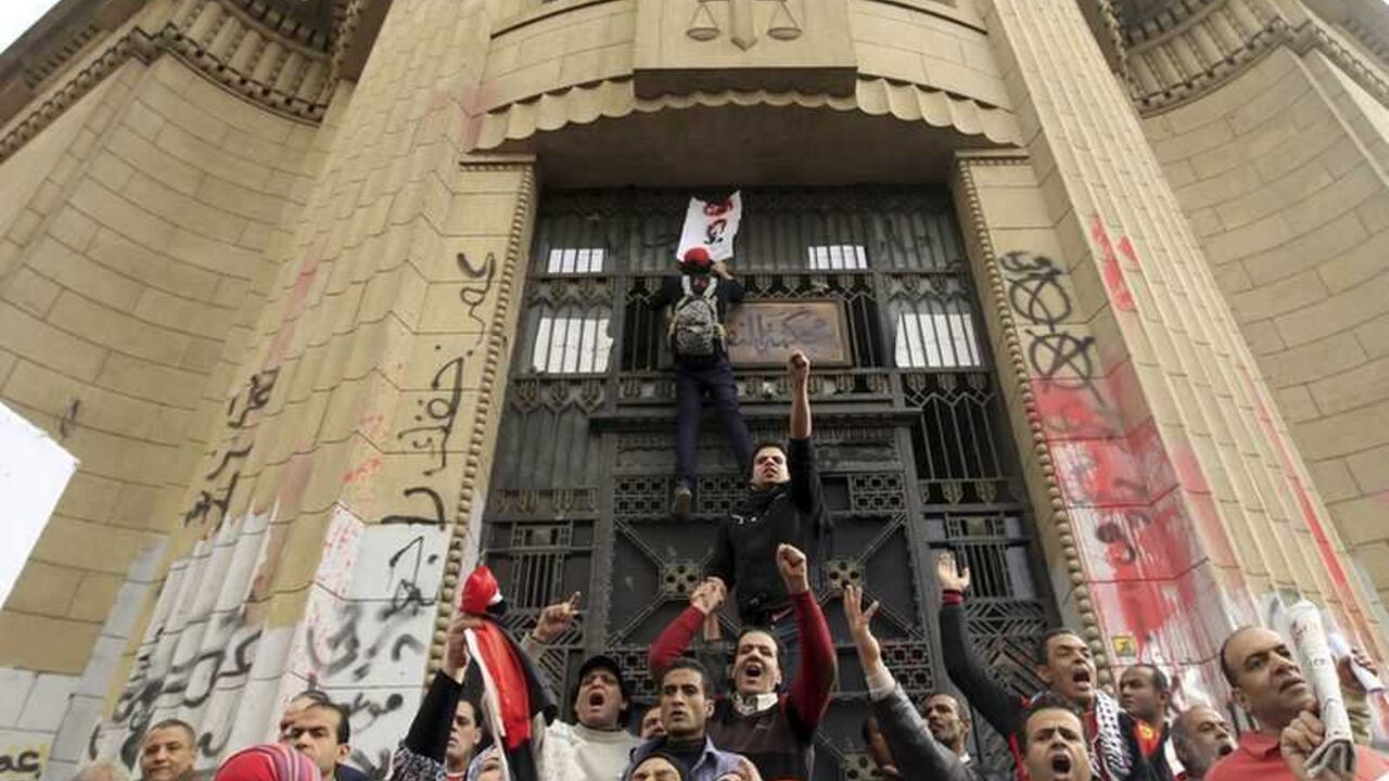 Protesters opposing Egyptian President Mursi shout in front of the courthouse and Office of the Attorney General during a protest near Tahrir Square in Cairo Protesters opposing Egyptian President Mohamed Mursi shout in front of the courthouse and Office of the Attorney General, which has been graffitied with anti-government slogans, during a protest against Mursi and members of the Muslim Brotherhood, near Tahrir Square in Cairo February 22, 2013. President Mohamed Mursi on Thursday called parliamentary elections that will begin on April 27 and finish in late June, a four-stage vote that the Islamist leader hopes will conclude Egypt's turbulent transition to de