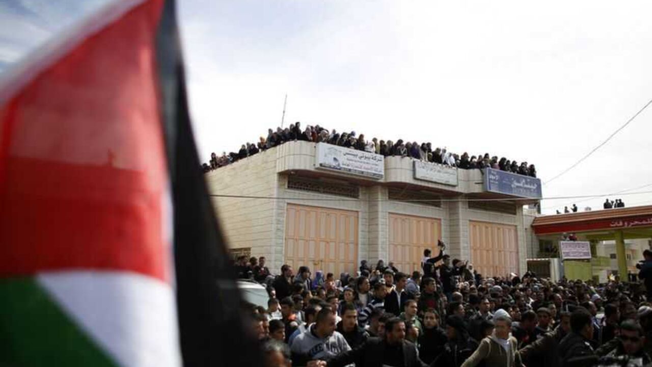 Palestinians attend the funeral of Arafat Jaradat in the West Bank village of Se'eer, near Hebron Palestinians attend the funeral of Arafat Jaradat in the West Bank village of Se'eer, near Hebron February 25, 2013. Israeli soldiers turned out in force on Monday for the funeral of Jaradat, who was arrested just one week ago for throwing stones at Israeli cars in the West Bank. Jaradat's death in an Israeli jail on Saturday and a hunger strike by four other prisoners have raised tension in the West Bank, where stone-throwers have clashed repeatedly with Israeli soldiers in recent days. REUTERS/Ammar Awad