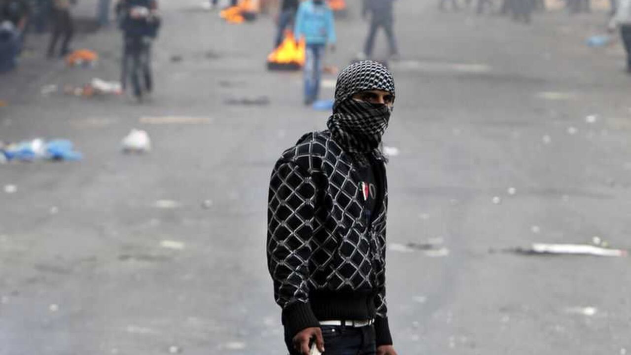 A Palestinian protester holds stones during clashes with Israeli soldiers in the West Bank city of Hebron February 25, 2013 following the funeral of Palestinian prisoner Arafat Jaradat. Jaradat's death in an Israeli jail on Saturday and a hunger strike by four other Palestinian inmates have raised tension in the occupied territory after repeated clashes between stone-throwers and Israeli soldiers in recent days. REUTERS/Ammar Awad (WEST BANK - Tags: POLITICS CIVIL UNREST) - RTR3EAAX
