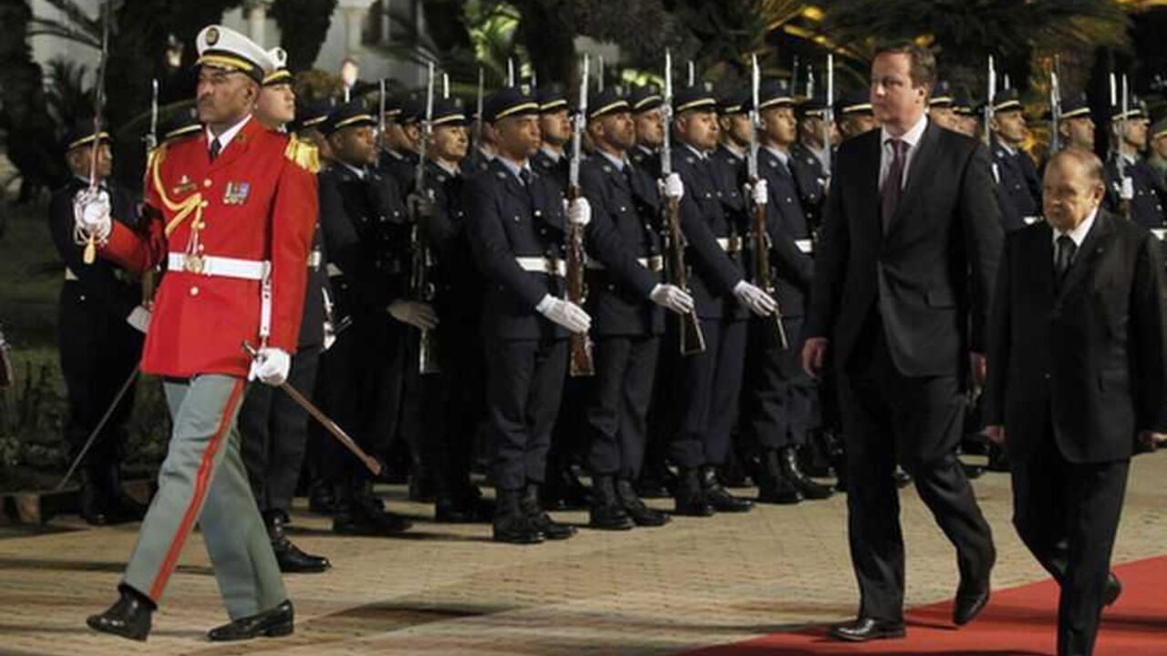 Algerian President Bouteflika and British PM Cameron review the honour guard during a welcoming ceremony in Algiers Algerian President Abdelaziz Bouteflika (R) and British Prime Minister David Cameron (2nd R) review the honour guard during a welcoming ceremony at the Presidential Palace in Algiers January 30, 2013. REUTERS/Louafi Larbi (ALGERIA - Tags: POLITICS) - RTR3D62J