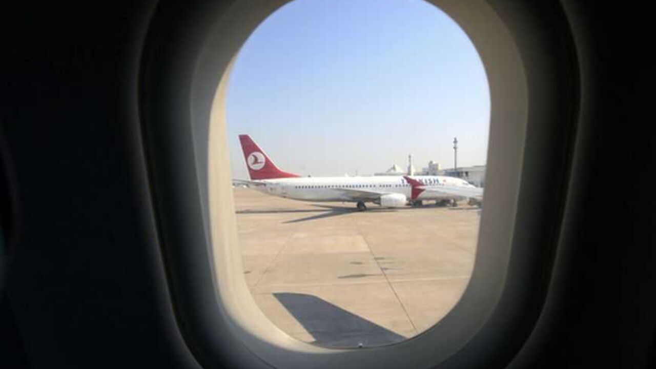 A Turkish Airlines Boeing 737 is seen through a window of another passenger plane at the airport in the Mediterranean coastal city of Antalya A Turkish Airlines Boeing 737 is seen through a window of another passenger plane at the airport in the Mediterranean coastal city of Antalya August 9, 2007. Turkish Airlines staff have been balloted this week on whether to strike for more pay at the height of the tourist season. REUTERS/Fatih Saribas (TURKEY) - RTR1SN2P