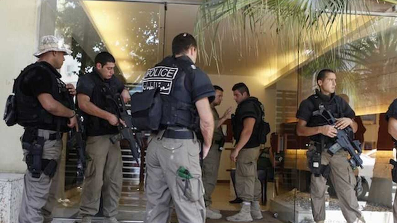 Lebanese policemen stand guard at entrance of building where former Lebanese government minister Samaha lives in Beirut Lebanese policemen stand guard at the entrance of a residential building where former Lebanese government minister Michel Samaha lives, in Beirut August 9, 2012. Samaha, a former Lebanese government minister with close ties to Syrian President Bashar al-Assad, was detained in Lebanon on Thursday for questioning over what the Lebanese prime minister described as security-related matters. A security source said Samaha, detained in the early hours, was being questioned about alleged plans to cause instability