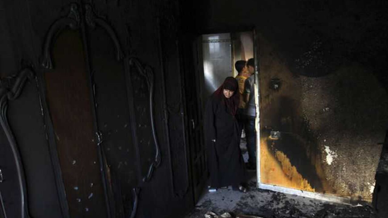 Palestinian woman looks at a burnt room of three-year-old boy al-Bogdadi in the central Gaza Strip A Palestinian woman looks at a burnt room of three-year-old boy Fathi al-Bogdadi in Bureij refugee camp in the central Gaza Strip September 26, 2012. Al-Bogdadi died and his infant sister suffered critical burns when a candle lit amid a power outage burnt their house down. REUTERS/Ibraheem Abu Mustafa (GAZA - Tags: POLITICS DISASTER) - RTR38FOR