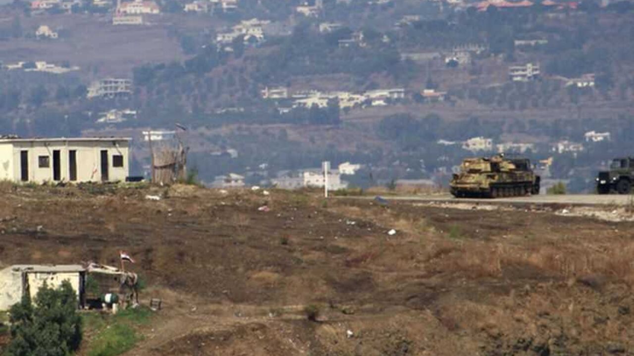 Syrian military vehicles are seen from Aboudiyeh village near the Syrian border, in northern Lebanon Syrian military vehicles are seen from Aboudiyeh village near the Syrian border, in northern Lebanon, October 9, 2012. REUTERS/Omar Ibrahim (LEBANON - Tags: CIVIL UNREST POLITICS MILITARY) - RTR38Y91