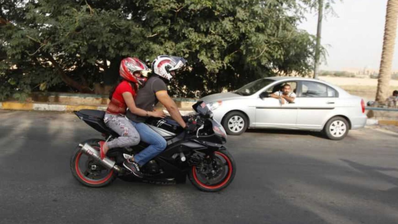 An Iraqi couple ride a motorbike during a biker show on Abu Nawas Street in Baghdad An Iraqi couple ride a motorbike during a biker show on Abu Nawas Street in Baghdad October 19, 2012. Drag-racing in California, you say? No, this is Baghdad, where youthful rebellion and American biker style clash with conservative mores in Iraq, a country where just a few years ago militias imposed their own radical Islamic views at gunpoint. Picture taken October 19, 2012. To match Feature IRAQ-CULTURE/BIKERS REUTERS/Saad Shalash (IRAQ - Tags: SOCIETY SPORT MOTORSPORT) - RTR39IOY
