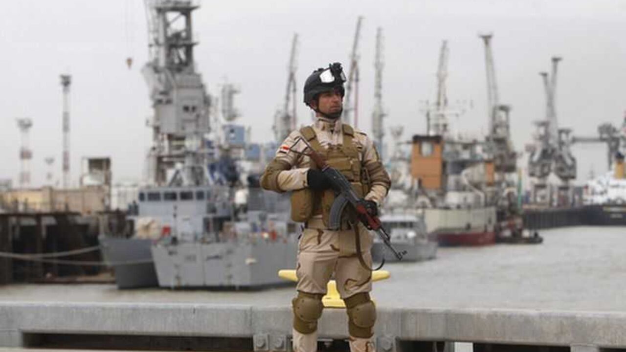An Iraqi soldier stands guard during a ceremony to receive two American- built vessels at Iraq's southern province of Basra An Iraqi soldier stands guard during a ceremony to receive two American- built vessels at Iraq's southern province of Basra, December 20, 2012. Iraqi navy received on Thursday the first two American-built vessels to boost surface force martial and secure the largest oil and commercial port in southern rich oil city of Basra. Ceremony took place on military base in Umm Qasr port south of Basra attended by Iraqi and U.S. military commanders and officials. Iraq and United States signed a contract late on 2009