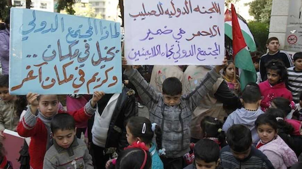 Palestinian children who were living in Yarmouk Palestinian refugee camp before fleeing Syria, hold up banners during protest in Beirut Palestinian children who were living in the Yarmouk Palestinian refugee camp before fleeing Syria, hold up banners during a protest in front of the International Committee of the Red Cross (ICRC) in Beirut January 17, 2013. Banners read, "The International Committee of the Red Cross is the conscience of the international community towards refugees" (R) and "Why the international community miserly to some places, and generous in some others?". REUTERS/Sharif Karim (LEBANON - Tags: SOCIETY IMMIGRATION POLITI