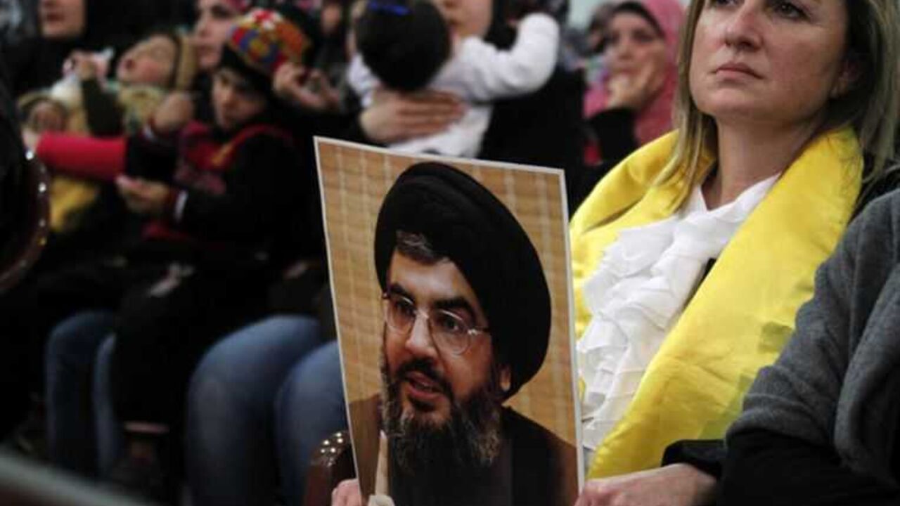 A woman holds a picture of Lebanon's Hezbollah leader Sayyed Hassan Nasrallah during a rally to commemorate the birth of Prophet Mohammad in Beirut's suburbs A woman holds a picture of Lebanon's Hezbollah leader Sayyed Hassan Nasrallah during a rally to commemorate the birth of Prophet Mohammad in Beirut's suburbs, January 25, 2013. REUTERS/Sharif Karim (LEBANON - Tags: POLITICS) - RTR3CY5K