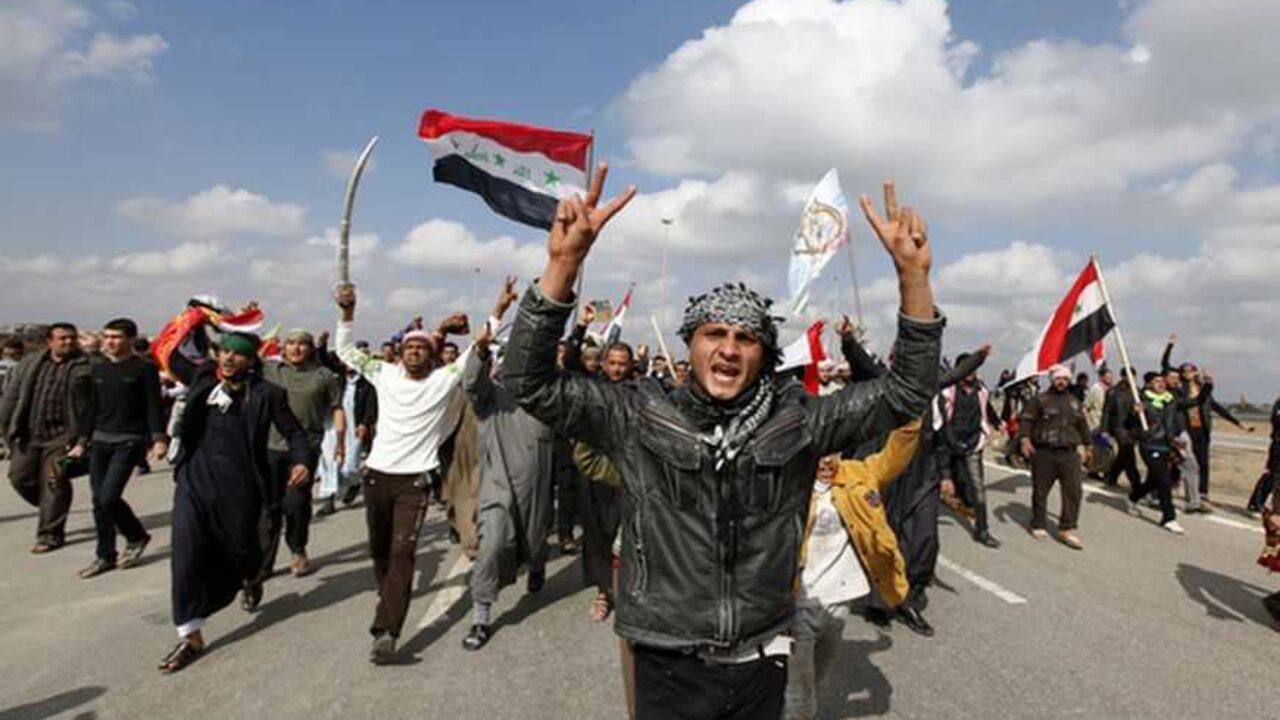 Iraqi Sunni Muslims shout slogans during an anti-government demonstration in Falluja Iraqi Sunni Muslims shout slogans during an anti-government demonstration in Falluja, 50 km (30 miles) west of Baghdad,February 1, 2013. Chanting "No" to Iraqi Prime Minister Nuri al-Maliki, tens of thousands of Sunni Muslims protested after Friday prayers in huge rallies against the Shi'ite premier that are raising the spectre of renewed sectarian unrest. REUTERS/Thaier Al-Sudani (IRAQ CONFLICT - Tags: POLITICS CIVIL UNREST TPX IMAGES OF THE DAY) - RTR3D8BA
