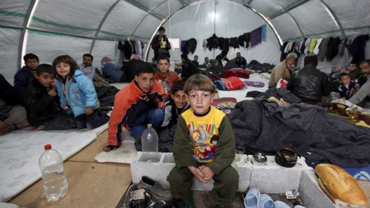 Syrian refugees sit in a tent at a refugee camp in the town of Nizip in Gaziantep province Syrian refugees sit in a tent at a refugee camp in the town of Nizip in Gaziantep province, southeast Turkey, February 11, 2013. REUTERS/Umit Bektas (TURKEY - Tags: POLITICS SOCIETY IMMIGRATION TPX IMAGES OF THE DAY) - RTR3DNGY