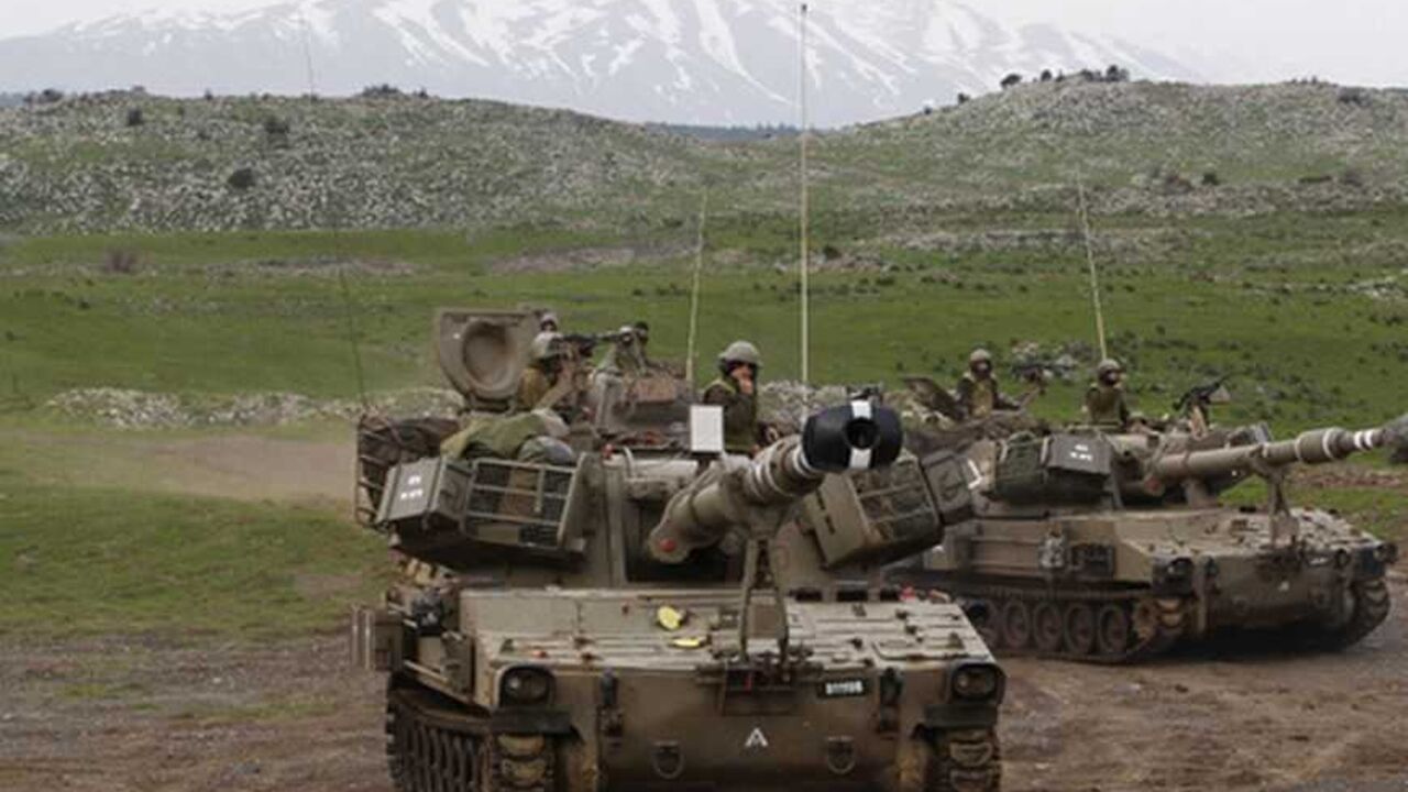 Mount Hermon is seen in the background as Israeli soldiers travel on mobile artillery units after an exercise in the Golan Heights Mount Hermon is seen in the background as Israeli soldiers travel on mobile artillery units after an exercise in the Golan Heights, near Israel's border with Syria February 14, 2013. Israel captured the Golan Heights from Syria in the 1967 Middle East war and annexed the territory in 1981, a move not recognised internationally. REUTERS/Baz Ratner (POLITICS MILITARY) - RTR3DSD4