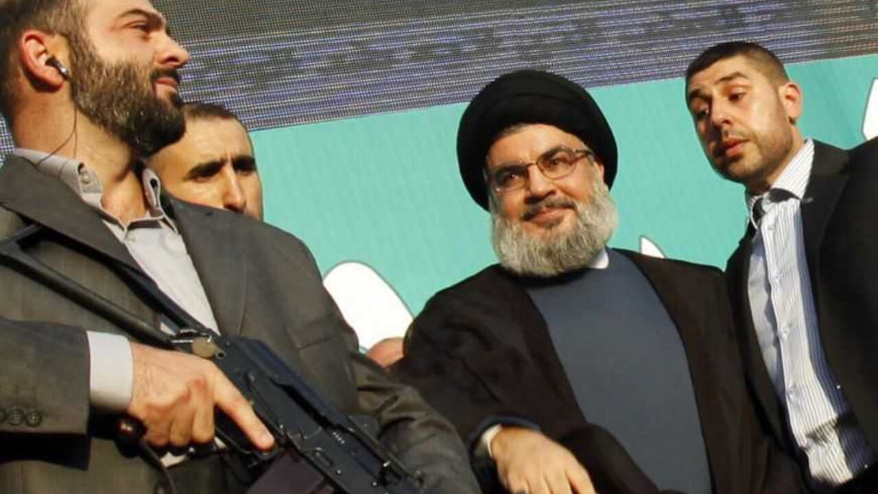 Lebanon's Hezbollah leader Sayyed Hassan Nasrallah greets his supporters at an anti-U.S. protest in Beirut's southern suburbs Lebanon's Hezbollah leader Sayyed Hassan Nasrallah (2nd R), escorted by his bodyguards, greets his supporters at an anti-U.S. protest in Beirut's southern suburbs September 17, 2012. Nasrallah made a rare public appearance on Monday to address tens of thousands of marchers protesting against a film made in the United States that mocks the Prophet Mohammad. Nasrallah has been living in hiding to avoid assassination since Hezbollah fought a month-long war with Israel in 2006. REUTERS/Sharif Karim (LEBANON - T