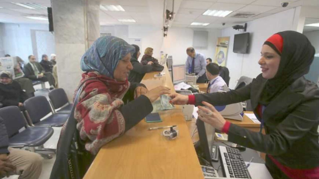 A Palestinian woman makes a withdrawal at the Housing Bank for Trade & Finance in the West Bank city of Ramallah A Palestinian woman makes a withdrawal at the Housing Bank for Trade & Finance in the West Bank city of Ramallah January 22, 2013. A central bank in the making, the Palestine Monetary Authority (PMA) is a rare bright spot as the economy of the Palestinian territories struggles with Israeli sanctions. Enforcing on Palestinian banks a regimen of conservative lending that has kept bad loans minimal and guaranteed liquidity, the PMA's technocratic prowess is the pinnacle of a Palestinian drive to build institut